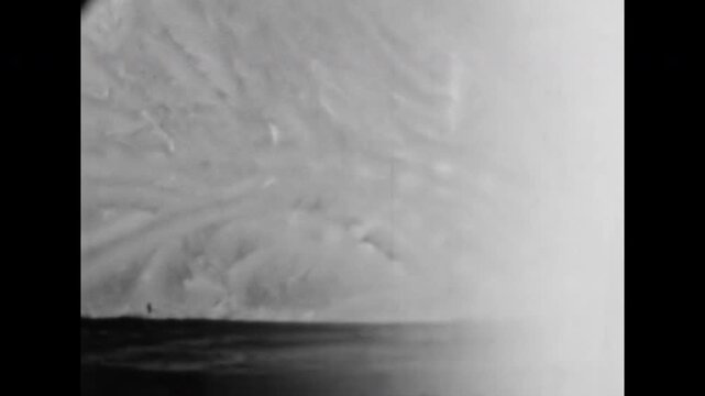 Close up, abstract frosty patterns on window glass in winter. Cold black and white Christmas decor background. Macro crystallization of ice crystal. Old film. Archival retro 1960s. Vintage archive.