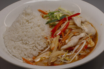 Steamed rice served with tender chicken in aromatic curry sauce, sliced peppers and bean sprouts, silky broth pooling around grains, warm spices and balanced