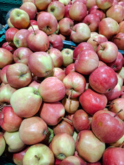 Red and green apples on supermarket shelves