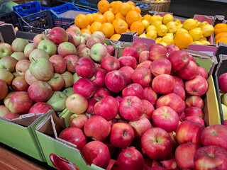 Red apples, lemons and oranges. Fruits on supermarket shelves