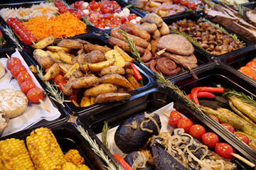 Meat, fried champignon mushrooms and potatoes, corn, tomatoes, pickle