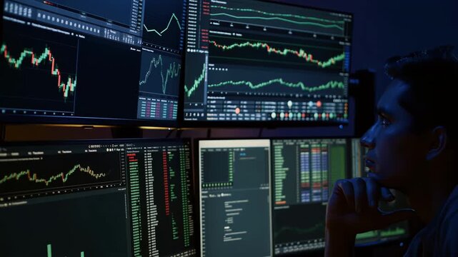 night trading desk monitors display charts. focused male trader reviews candlestick patterns, live tickers, portfolio analytics and code terminals on multi screen setup in dimly lit room, blue glow