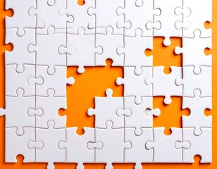 Close-up view of a partially assembled jigsaw puzzle with missing pieces on a vibrant orange background