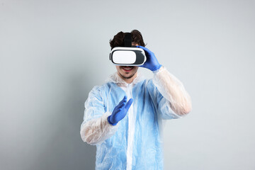 Modern technology. Doctor using virtual reality headset on grey background