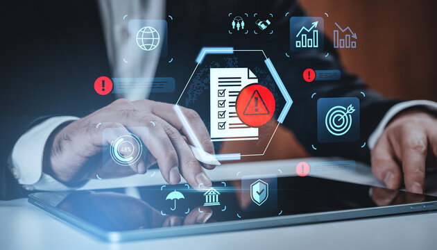 Businessman's hands using tablet with digital risk management concept icons and alerts on futuristic creative background in corporate setting.