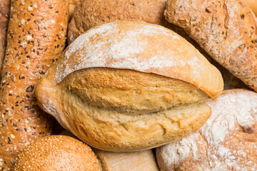 Homemade natural breads. Different kinds of fresh bread as background, top view with copy space