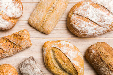 Homemade natural breads. Different kinds of fresh bread as background, top view with copy space