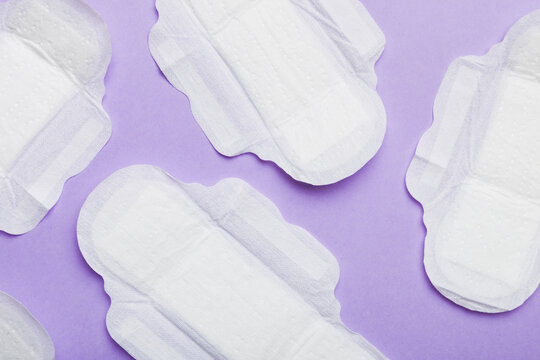 Women hygiene products or sanitary pad on colored background. Pastel color. Closeup. Empty place for text. Female daily hygiene