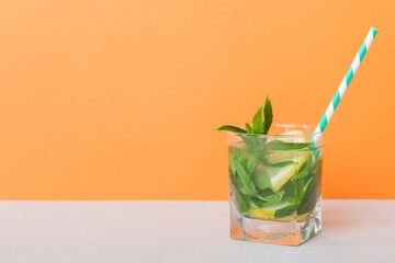 Mojito summer refreshing cocktail with ice and mint. mojito cocktail with lime, lemon and mint in a tall glass with a stick