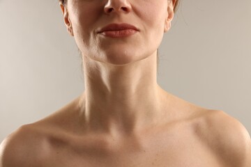 Woman with normal skin on light grey background, closeup