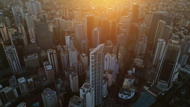 Aerial view of skyscrapers buildings in Makati business district and Manila city at sunset, capital of Philippines, 4k