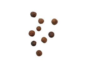 Mix of whole  pieces of black pepper, peppercorns or allspice isolated on white, top view, clipping path, PNG.