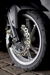 Front wheel of automatic motorbike stock photo