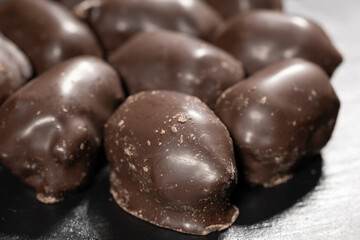 Large dark chocolate candies on dark background