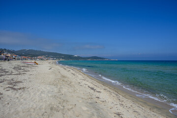 Empty shoreline without people and turquoise water at Sarti Beach, Greece