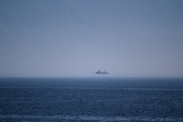 Solitary ship in sea fog