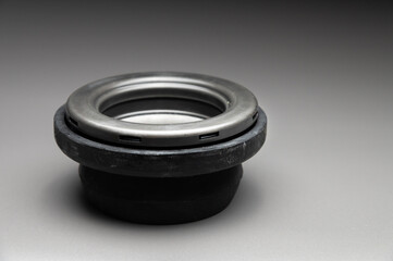 A new two-piece front strut support bearing. The new part is shown on a black gradient background.