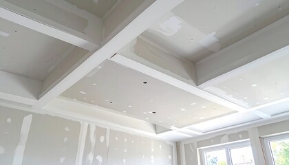 Interior angle shot of freshly installed, unpainted drywall ceiling and walls, featuring beams. Visible imperfections