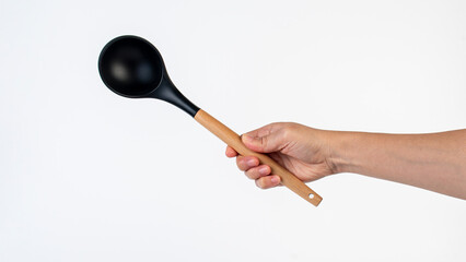 Black plastic spatula in hand on white background
