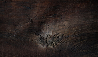 Dark rustic wooden background with scratches, grain and subtle texture — suitable as moody backdrop.