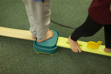 Students work together on challenging obstacle course with instructor supervision and safety emphasis