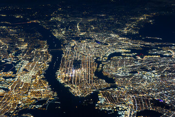 Aerial night view of New York City with illuminated grid