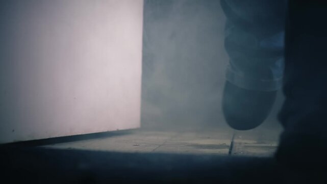 Person leaving dark smoke filled room through door