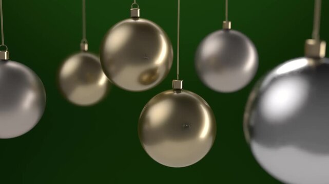 Gold and silver baubles on a green background