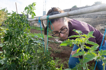Young woman working on an outdoor field plantation