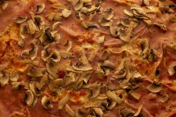 Pizza with mushrooms close-up served as a meal, showing baked food presentation and reflecting popular cuisine. Fast food culture.