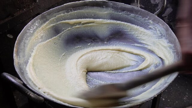 Person preparing Sandesh is a classic Bengali sweet