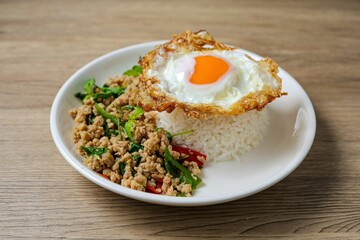 Stir-fried minced chicken with holy basil served with steamed rice and fried egg.
