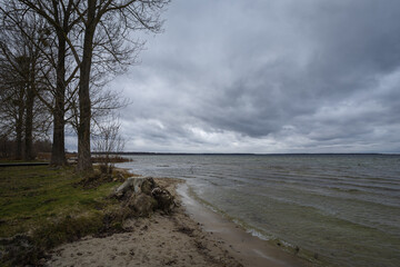 Lake in windy and cloudy weather. Autumn