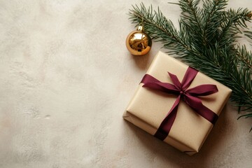 Kraft-wrapped gift box with magenta ribbon on soft beige surface.