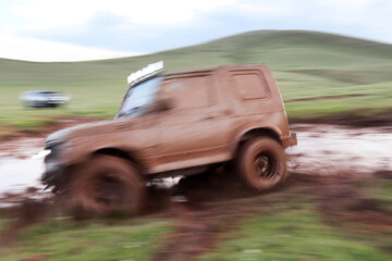 Fototapeta premium Jeep off road in muddy conditions
