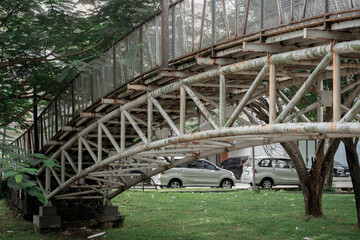 Side view of an old white steel truss bridge crossing a river with visible rust and peeling paint.