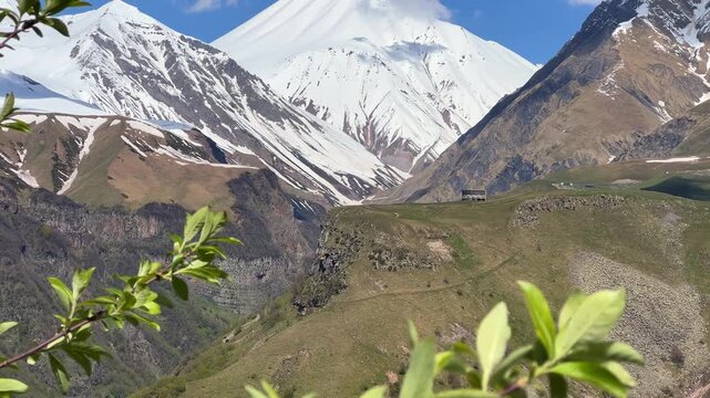 GUDAURI, GEORGIA - APRIL 26, 2024: Scenic view of the Devil's Gorge and the Arch of Friendship. The Caucasus Mountains in the area of the Peoples' Friendship Arch on the Georgian Military Road. 4K