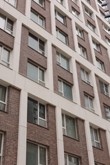 Modern residential building facade featuring brick and windows