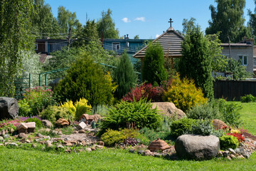 Beautiful flowerbed with flowering plants between the stones