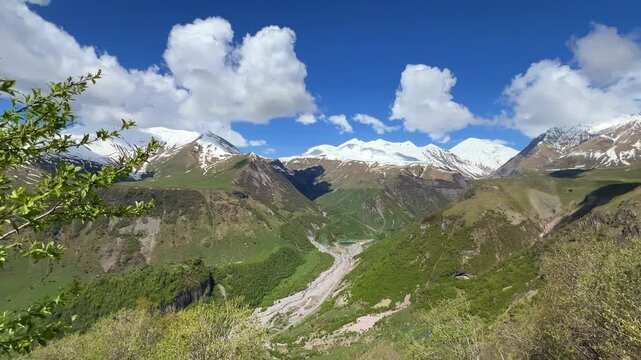 GUDAURI, GEORGIA - APRIL 26, 2024: Scenic view of the Devil's Gorge and the Arch of Friendship. The Caucasus Mountains in the area of the Peoples' Friendship Arch on the Georgian Military Road. 4K