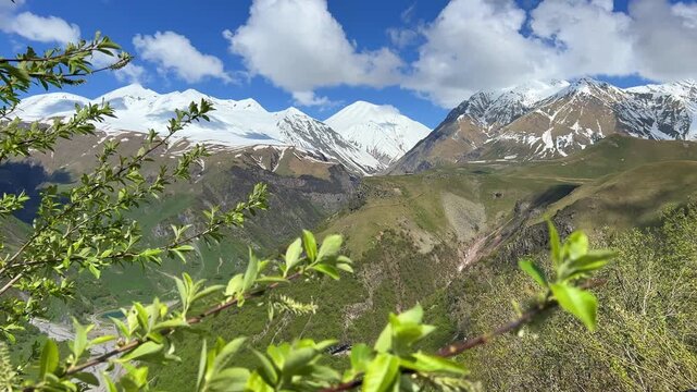 GUDAURI, GEORGIA - APRIL 26, 2024: Scenic view of the Devil's Gorge and the Arch of Friendship. The Caucasus Mountains in the area of the Peoples' Friendship Arch on the Georgian Military Road. 4K