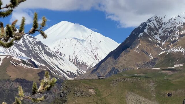 GUDAURI, GEORGIA - APRIL 26, 2024: Scenic view of the Devil's Gorge and the Arch of Friendship. The Caucasus Mountains in the area of the Peoples' Friendship Arch on the Georgian Military Road. 4K