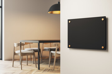 Blank black signage on modern interior wall near dining room table and chairs with soft lighting and minimalist decor concept. 3D Rendering