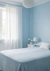 Bright and serene bedroom with light blue walls and white bedding.