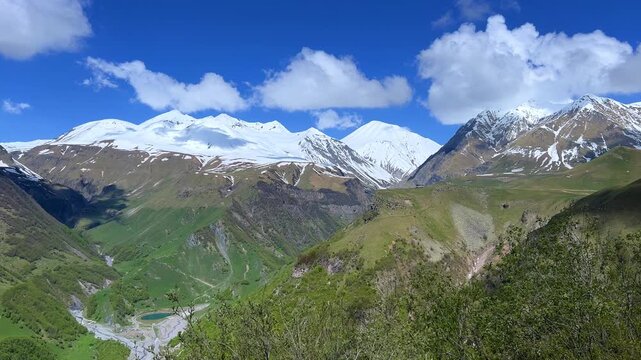 GUDAURI, GEORGIA - APRIL 26, 2024: Scenic view of the Devil's Gorge and the Arch of Friendship. The Caucasus Mountains in the area of the Peoples' Friendship Arch on the Georgian Military Road. 4K