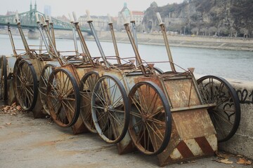 Rusty, large-wheeled wheelbarrows.