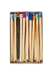 Box with Multicolored matchsticks with faces painted on the heads