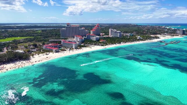 Panoramic aerial view of the popular beach at Goodmans Bay, Nassau, Bahamas, with water sports and turquoise ocean