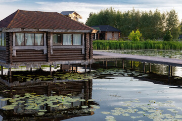 Gazebo on the shore of a pond on a summer evening