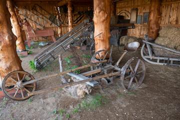 Vintage agricultural machinery and equipment in a farmyard in the countryside